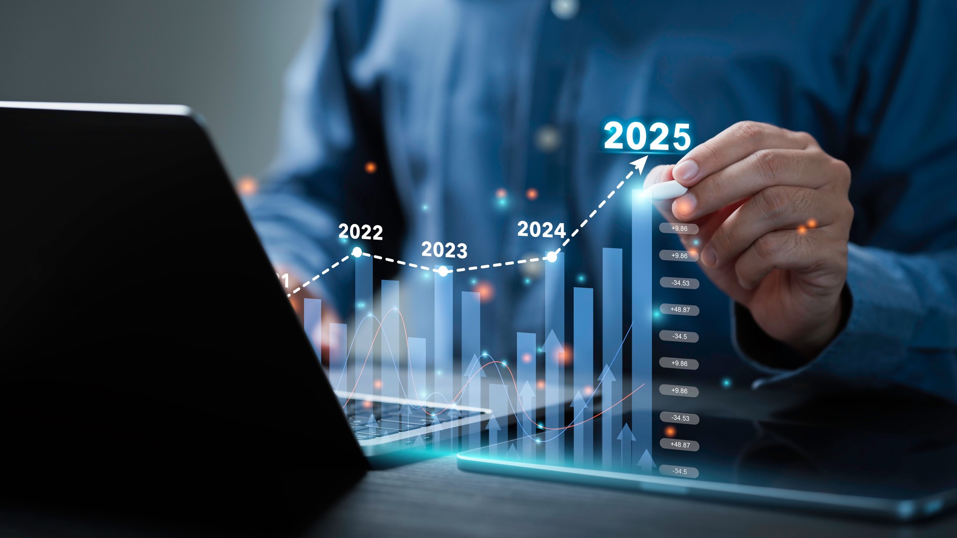 Businessman analyzes the graph of trend market growth in 2025 and plans business growth and profit increase in the year 2025. plan finances of the business